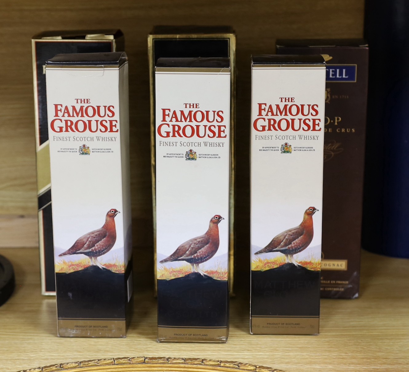 Six various bottles of cognac and whisky, to include two 1 litre boxed bottles of Remy Martin cognac, a boxed 1 litre bottle of Martell cognac, and three boxed 70cl bottles of The Famous Grouse whisky